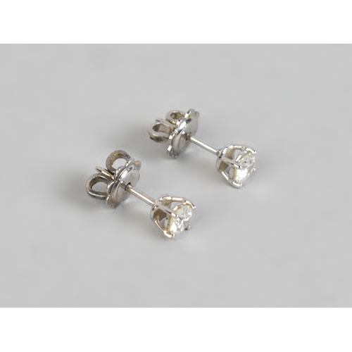 57 - A Pair of Diamond and White Metal Stud Earrings, Each Stone Measuring 4.1mm Diameter Approx, Support... 