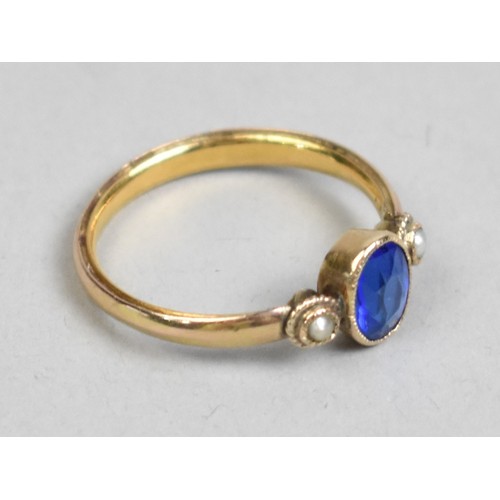 39 - A Garnet Topped Doublet Blue Stone Ring with Central Bezel Set Stone and Flanked by Two Seed Pearls,... 