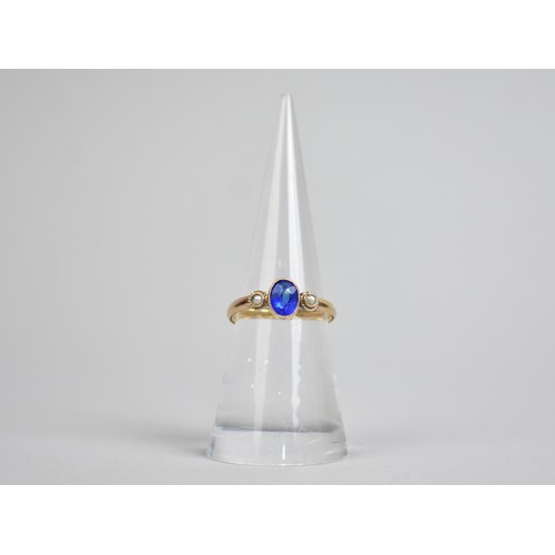 39 - A Garnet Topped Doublet Blue Stone Ring with Central Bezel Set Stone and Flanked by Two Seed Pearls,... 