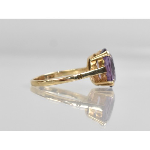36 - An Amethyst and 9ct Gold Dress Ring, Oval Cut Stone Measuring 12.8mm by 10.1mm Supported in Four Spl... 