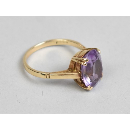 36 - An Amethyst and 9ct Gold Dress Ring, Oval Cut Stone Measuring 12.8mm by 10.1mm Supported in Four Spl... 