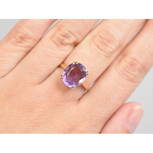 36 - An Amethyst and 9ct Gold Dress Ring, Oval Cut Stone Measuring 12.8mm by 10.1mm Supported in Four Spl... 