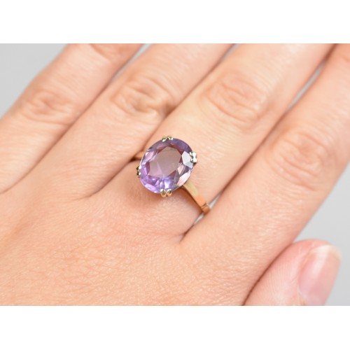 36 - An Amethyst and 9ct Gold Dress Ring, Oval Cut Stone Measuring 12.8mm by 10.1mm Supported in Four Spl... 
