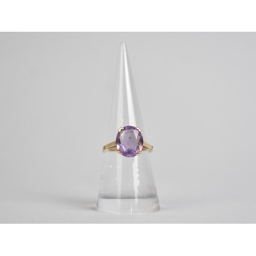 36 - An Amethyst and 9ct Gold Dress Ring, Oval Cut Stone Measuring 12.8mm by 10.1mm Supported in Four Spl... 