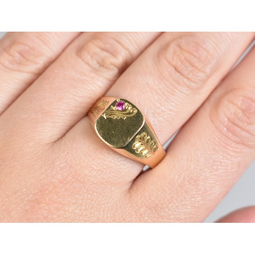 23A - A 14ct Gold and Ruby Signet Ring, Rectangular Head with Round Cut Grain Set Ruby, Engraved Shoulders... 