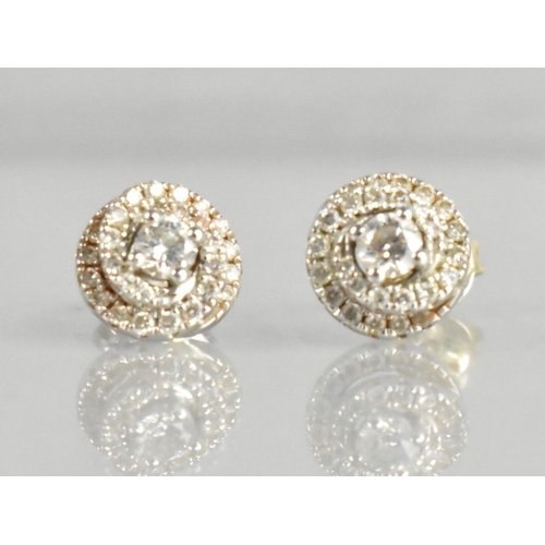 A Pair of 18ct White Gold and Diamond Earrings, Primary Brilliant Cut Stone Measuring 3mm Diameter, Supported in Four Claws and with Two Spiralled Halos of Accent Diamonds Around, Posts Stamped 750 Dia 0.25, Total Diameter 8.25mm, One Butterfly Back Stamped 18k, the Other 925