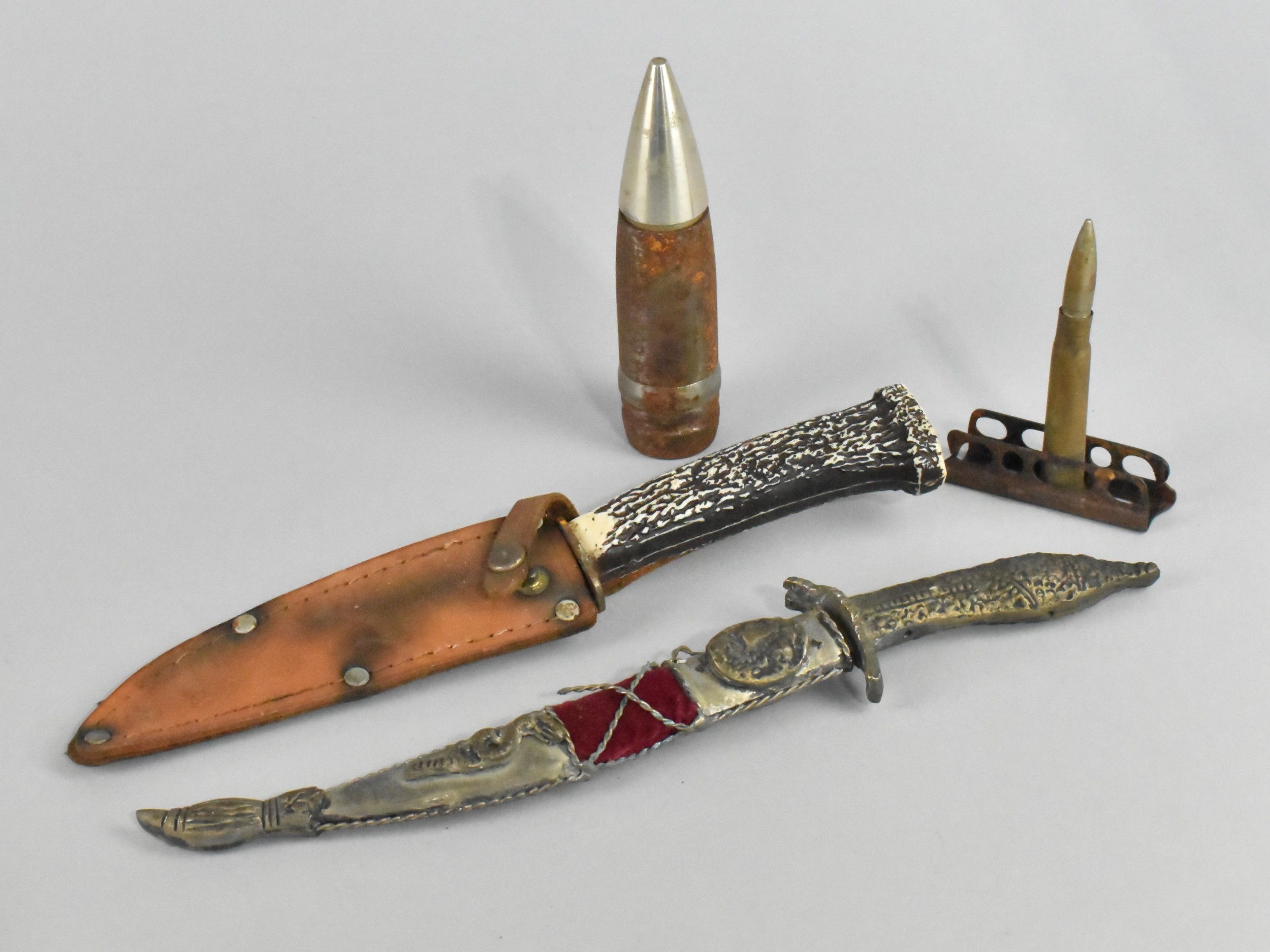 A Small Continental hunting knife with leather scabbard, a curved blade ...