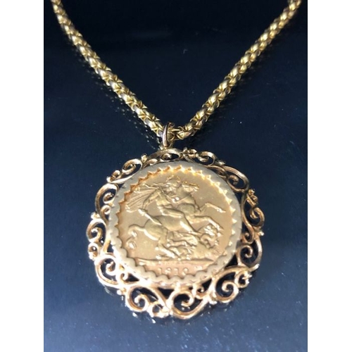 12 - A 1910 Full Gold sovereign in a pierced and scrolling style mount on a Long 9ct Gold chain (approx 7... 