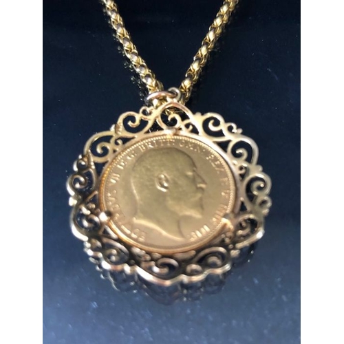 12 - A 1910 Full Gold sovereign in a pierced and scrolling style mount on a Long 9ct Gold chain (approx 7... 