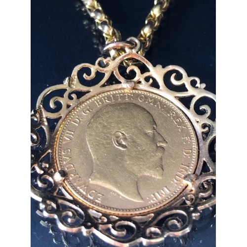 12 - A 1910 Full Gold sovereign in a pierced and scrolling style mount on a Long 9ct Gold chain (approx 7... 