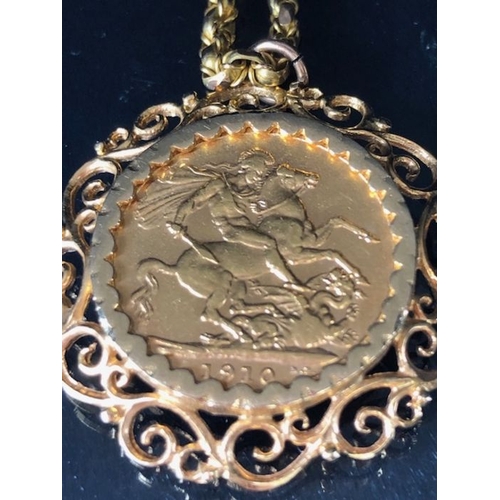 12 - A 1910 Full Gold sovereign in a pierced and scrolling style mount on a Long 9ct Gold chain (approx 7... 