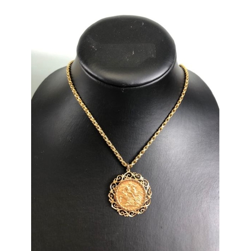 12 - A 1910 Full Gold sovereign in a pierced and scrolling style mount on a Long 9ct Gold chain (approx 7... 