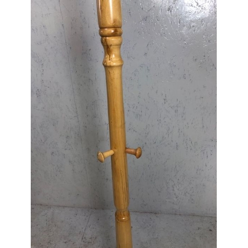 131 - Coat stand, modern light wood coat and hat stand on tripod base approximately 79 cm high