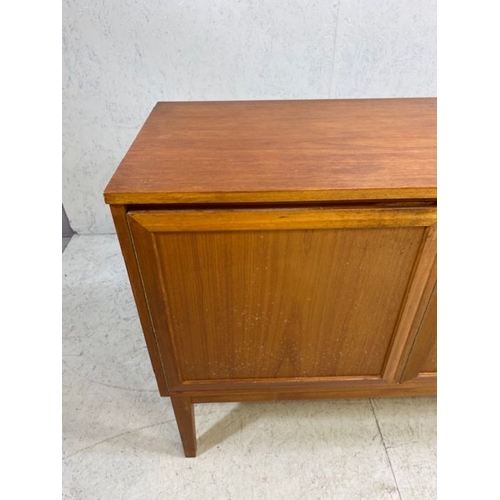 152 - Mid century furniture, 1970s long sideboard, on slayed legs  comprising of a 2 door central cupboard... 