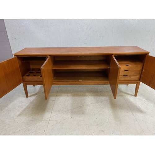 152 - Mid century furniture, 1970s long sideboard, on slayed legs  comprising of a 2 door central cupboard... 