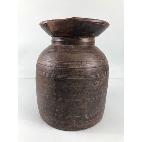 161 - Tribal interest, two Asia turned wooden Ghee pots of classic form the larger approximately 26cm high