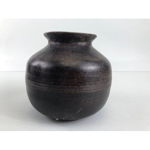 161 - Tribal interest, two Asia turned wooden Ghee pots of classic form the larger approximately 26cm high