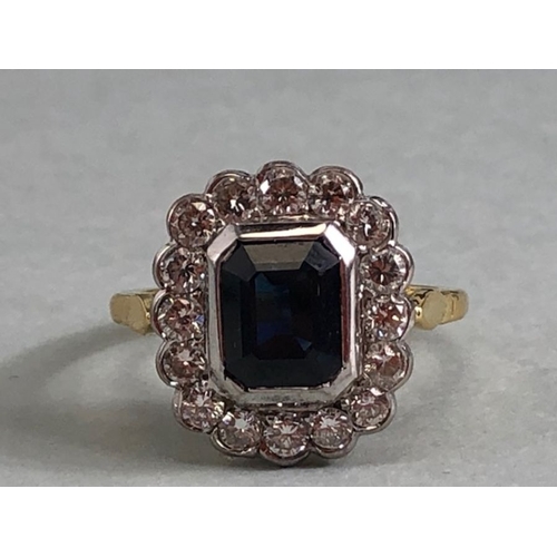 20 - 18ct yellow gold cluster ring ,cushion cut sapphire surrounded by diamonds mounted on a 18ct yellow ... 