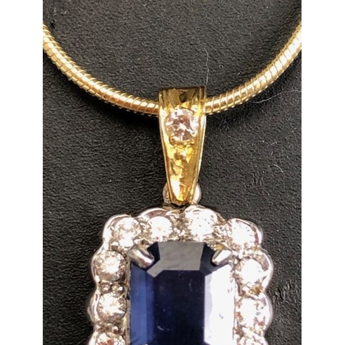 21 - 18ct sapphire and diamond pendant, cushion cut sapphire surrounded by diamonds on a rolled serpentin... 