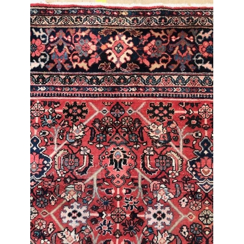 219 - Oriental rug, large wool eastern rug with flower and arabesque designs approximately 382 x 274cm