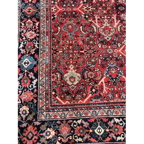 219 - Oriental rug, large wool eastern rug with flower and arabesque designs approximately 382 x 274cm