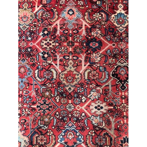 219 - Oriental rug, large wool eastern rug with flower and arabesque designs approximately 382 x 274cm