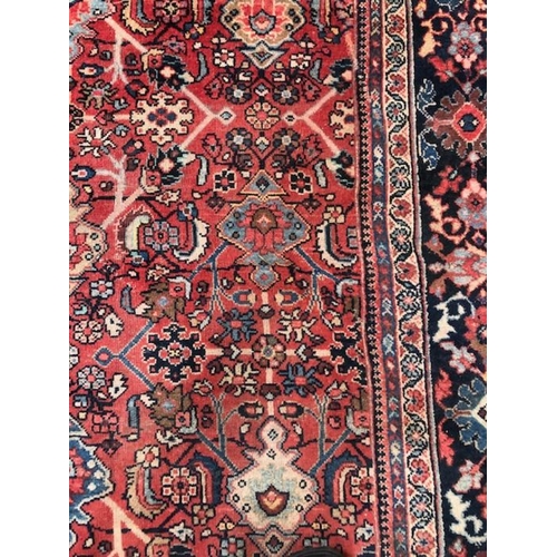 219 - Oriental rug, large wool eastern rug with flower and arabesque designs approximately 382 x 274cm