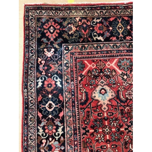 219 - Oriental rug, large wool eastern rug with flower and arabesque designs approximately 382 x 274cm