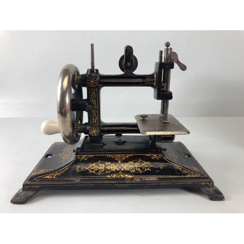 229 - Sewing Machine, Antique child's portable sewing machine by Leigh and Crawford with cover