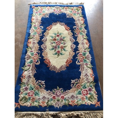 236 - Oriental Rug, Chinese wool rug with pattern of sculpted flowers on a Blue back ground approximately ... 