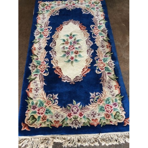 236 - Oriental Rug, Chinese wool rug with pattern of sculpted flowers on a Blue back ground approximately ... 