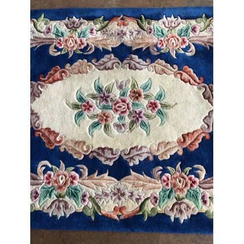 236 - Oriental Rug, Chinese wool rug with pattern of sculpted flowers on a Blue back ground approximately ... 