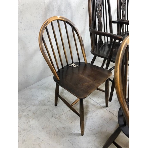 242 - Six stick back Ercol dining chairs, and two wheel back carver chairs