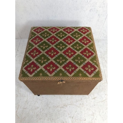 256 - Ottoman stool.  An Ottoman stool on casters, the top upholstered in red and green tapestry of Fleur ... 