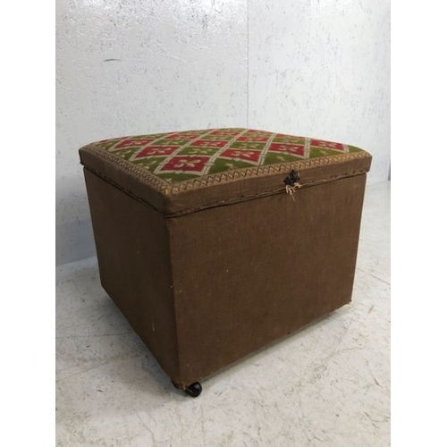 256 - Ottoman stool.  An Ottoman stool on casters, the top upholstered in red and green tapestry of Fleur ... 