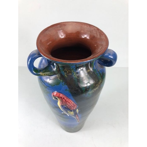 315 - Torquay pottery, a large salt glaze pottery vase with raised and sponge design of a colourful parrot... 