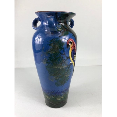 315 - Torquay pottery, a large salt glaze pottery vase with raised and sponge design of a colourful parrot... 