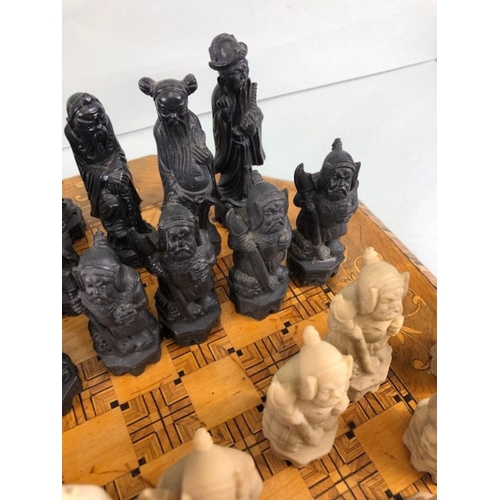 323 - Chess set, antique wooden marquetery chess board  and a chess set of Chinese immortals made from com... 