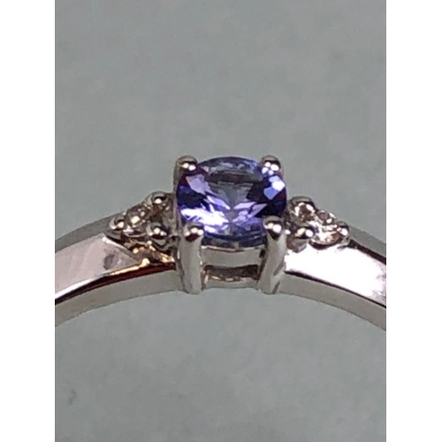 35 - 18k White gold ring set with Blue faceted Tanzanite stone and flanked by Diamond shoulders total wei... 