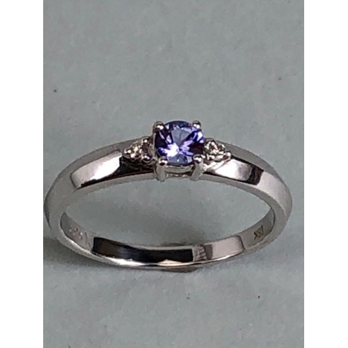 35 - 18k White gold ring set with Blue faceted Tanzanite stone and flanked by Diamond shoulders total wei... 