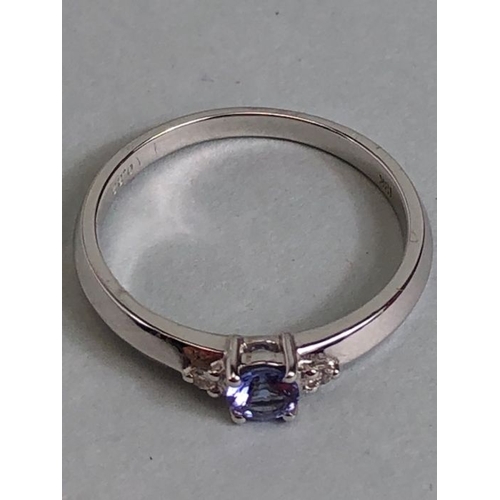 35 - 18k White gold ring set with Blue faceted Tanzanite stone and flanked by Diamond shoulders total wei... 