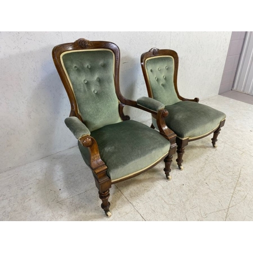 369 - His and Hers, Victorian upholstered button back armchairs, on original castors, with carved detailin... 