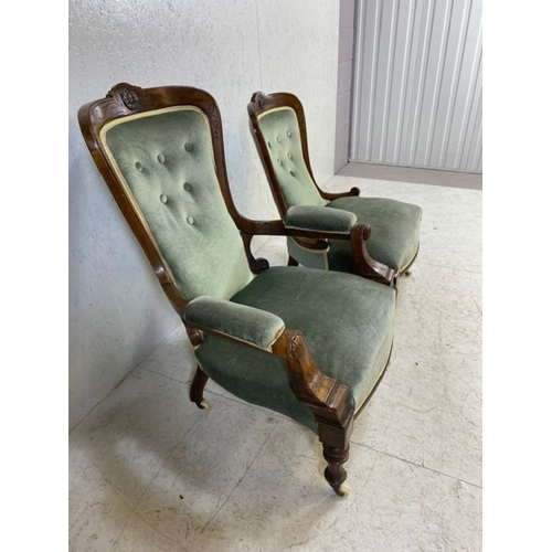 369 - His and Hers, Victorian upholstered button back armchairs, on original castors, with carved detailin... 