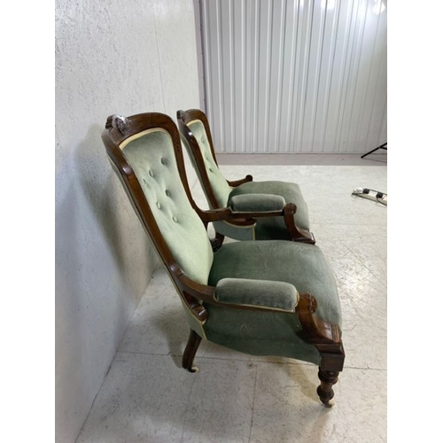 369 - His and Hers, Victorian upholstered button back armchairs, on original castors, with carved detailin... 