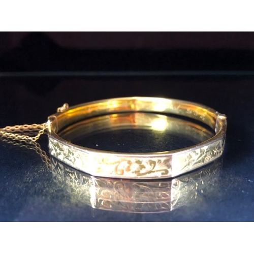 38 - 9ct fully hallmarked Gold bangle with floral engraving, good clasp and safety chain total weight app... 