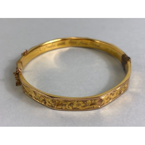 38 - 9ct fully hallmarked Gold bangle with floral engraving, good clasp and safety chain total weight app... 