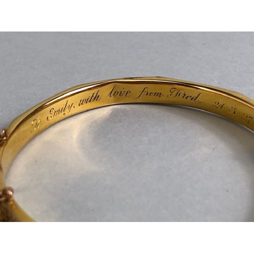 38 - 9ct fully hallmarked Gold bangle with floral engraving, good clasp and safety chain total weight app... 