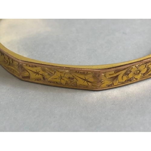 38 - 9ct fully hallmarked Gold bangle with floral engraving, good clasp and safety chain total weight app... 