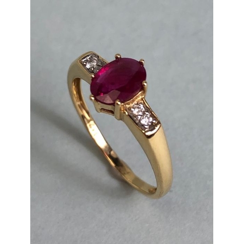 45 - 14ct Gold ring set with Oval faceted Ruby in claw setting with pair of diamonds to each shoulder siz... 