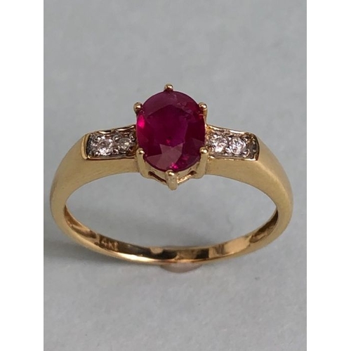 45 - 14ct Gold ring set with Oval faceted Ruby in claw setting with pair of diamonds to each shoulder siz... 